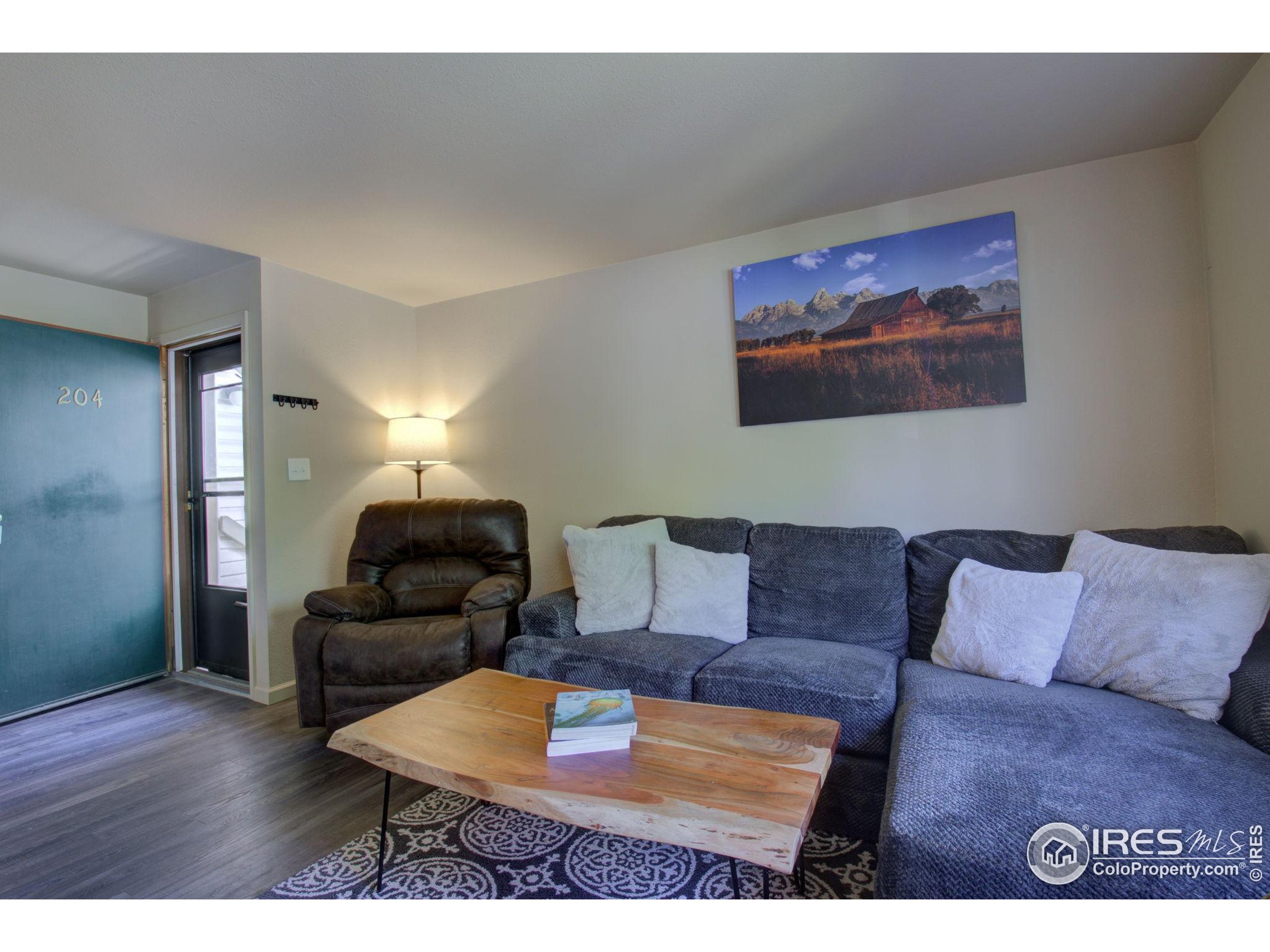 1705 Heatheridge Road, Unit M204 Fort Collins, CO 80526 - Photo 4 of 35 a living room with furniture and a wooden floor