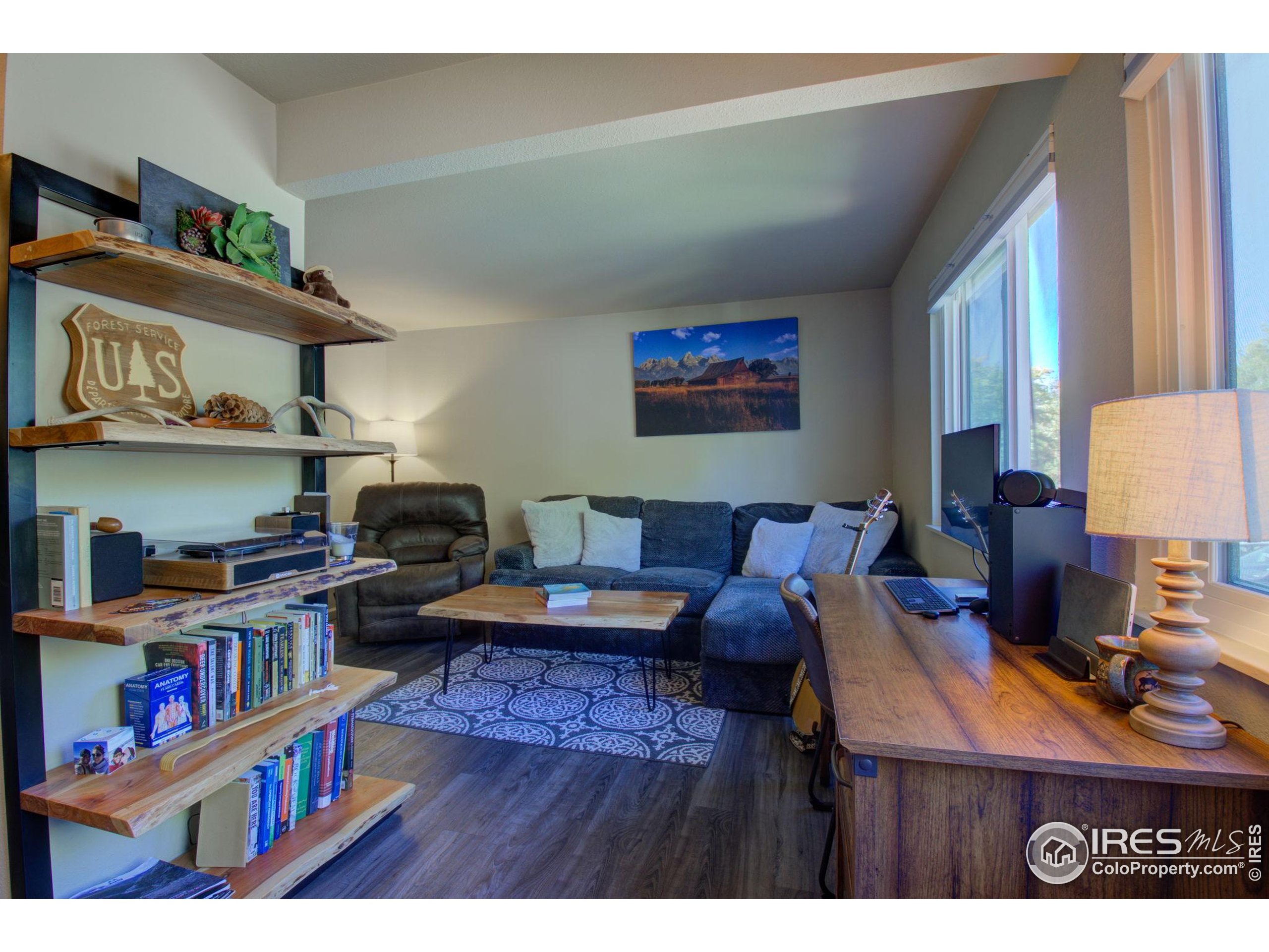 1705 Heatheridge Road, Unit M204 Fort Collins, CO 80526 - Photo 5 of 35 a living room with furniture and a book shelf