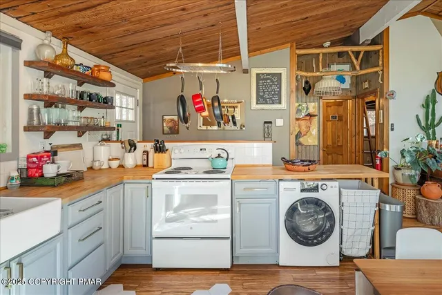 a utility room with sink dryer and washer