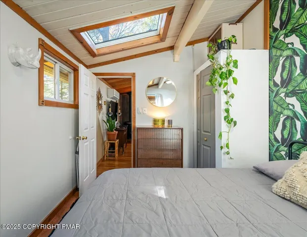 a bedroom with a bed and a potted plant