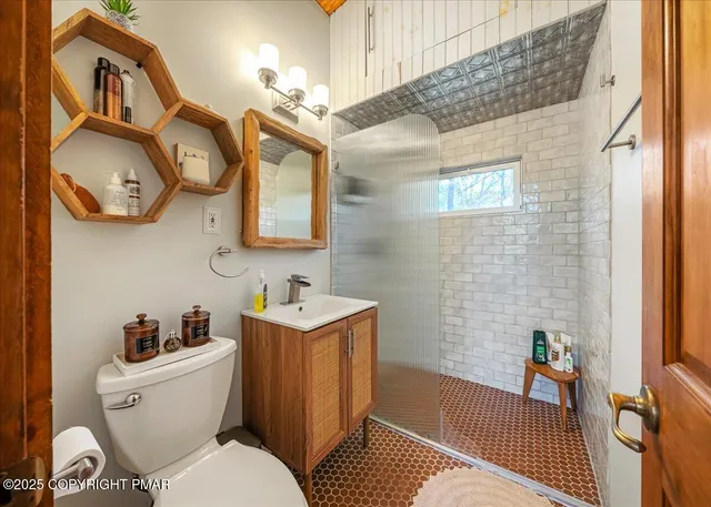 a white toilet sitting next to a bathroom sink