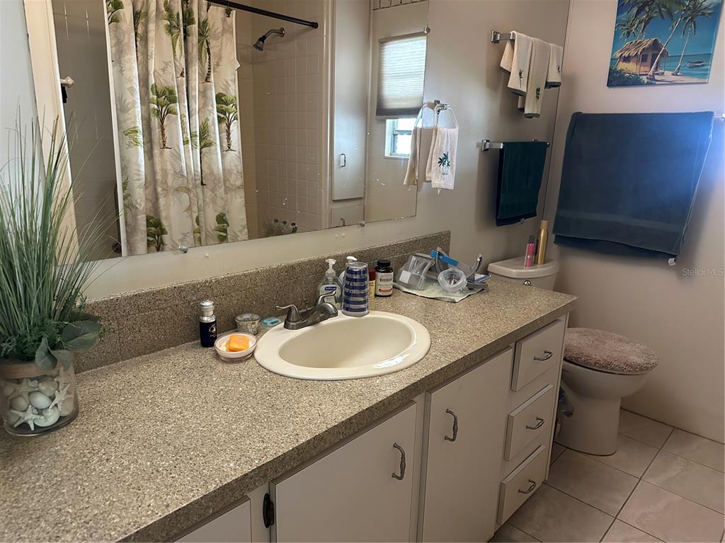 5800 Forsythia Road Venice, FL 34293 - Photo 12 of 27 a bathroom with a double vanity sink and a mirror