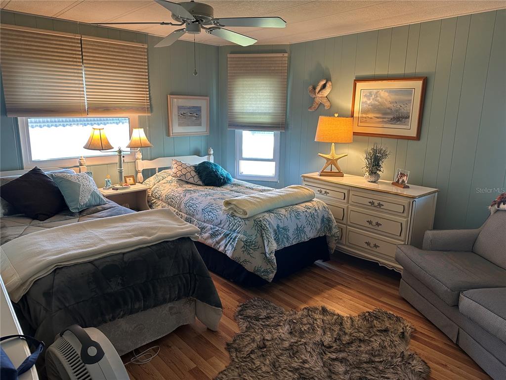 5800 Forsythia Road Venice, FL 34293 - Photo 13 of 27 a bedroom with a bed and a dresser next to a window