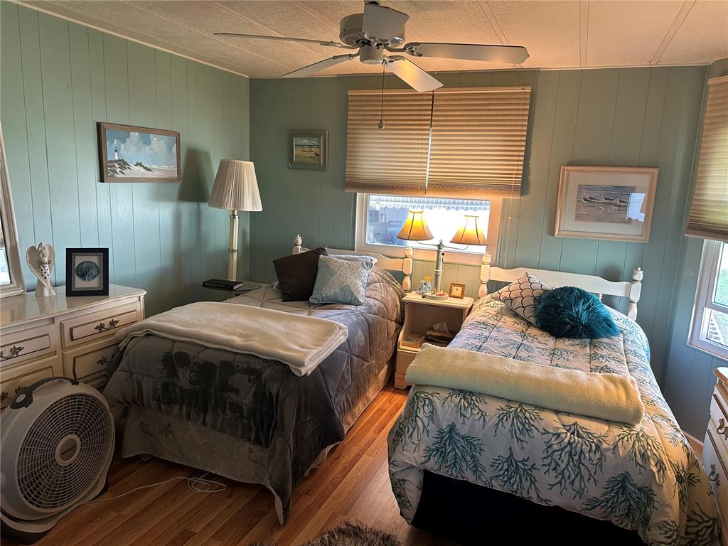 5800 Forsythia Road Venice, FL 34293 - Photo 14 of 27 a bedroom with a bed and a chandelier