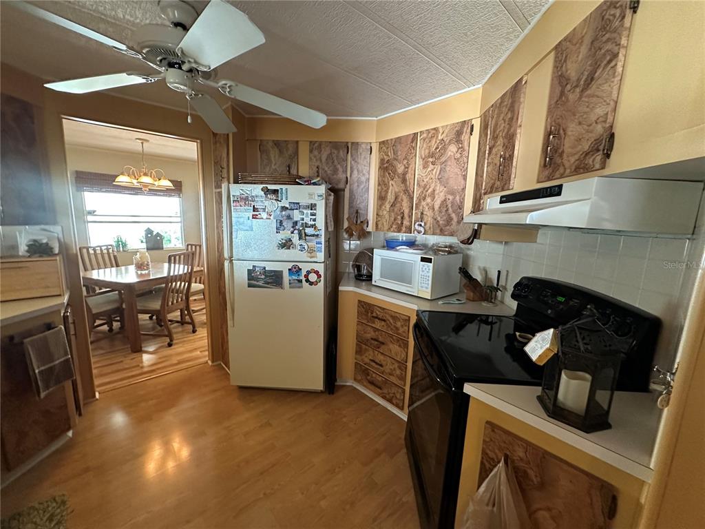 5800 Forsythia Road Venice, FL 34293 - Photo 3 of 27 a kitchen with stainless steel appliances granite countertop a stove a refrigerator and a sink