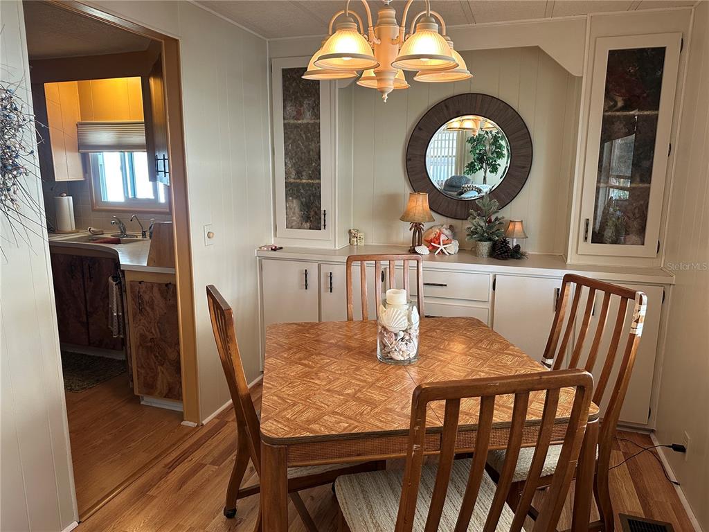 5800 Forsythia Road Venice, FL 34293 - Photo 5 of 27 a view of a dining room with furniture and chandelier