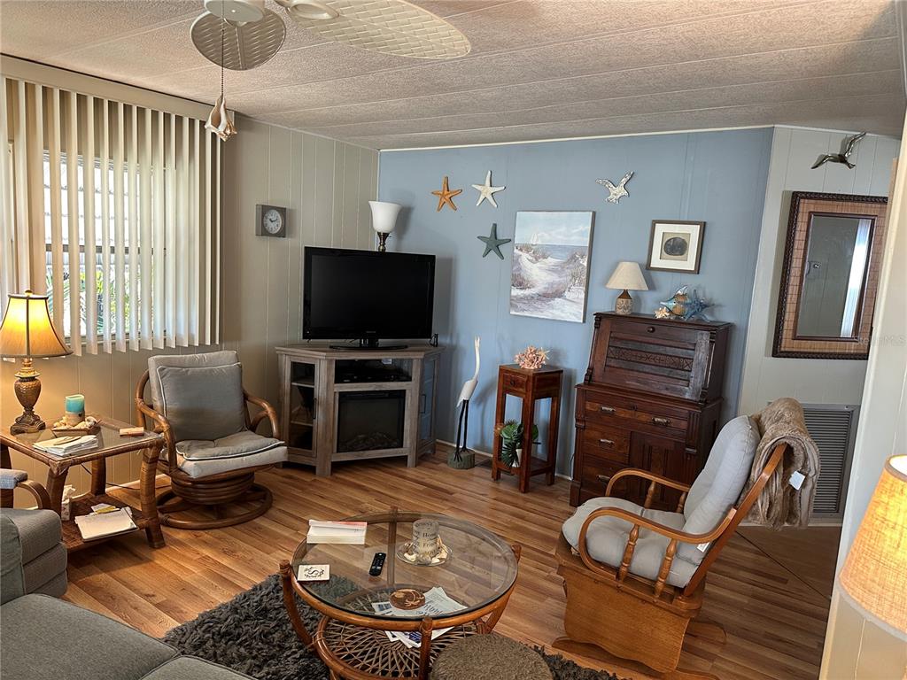 5800 Forsythia Road Venice, FL 34293 - Photo 7 of 27 a living room with furniture and a flat screen tv
