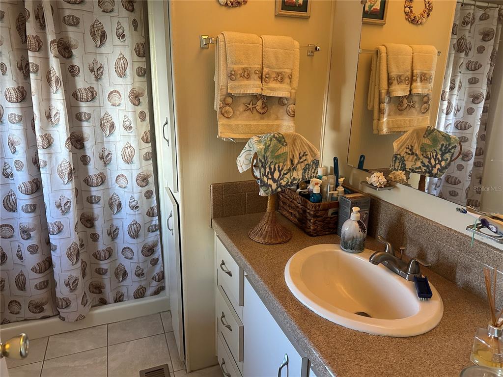 5800 Forsythia Road Venice, FL 34293 - Photo 10 of 27 a bathroom with a sink and a mirror
