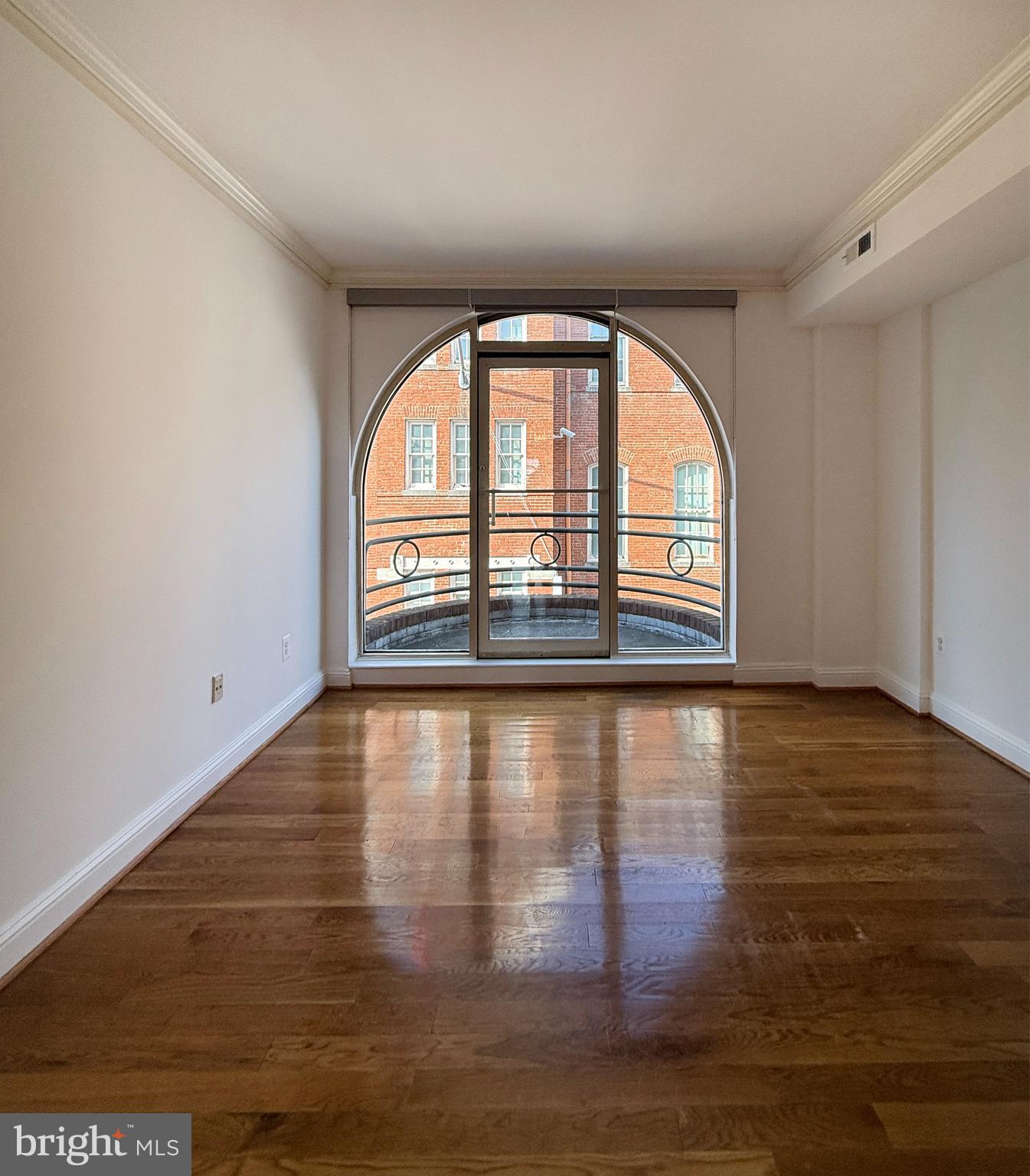 2719 M Street Northwest, Unit 2719 Washington, DC 20007 - Photo 11 of 21 wooden floor in an empty room with a window