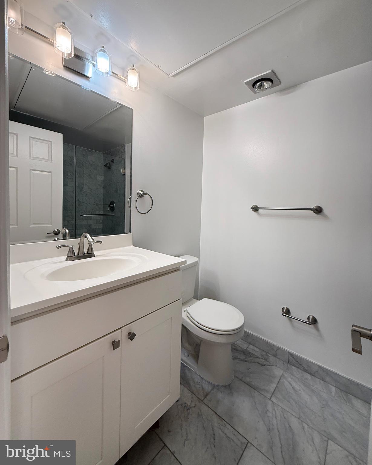 2719 M Street Northwest, Unit 2719 Washington, DC 20007 - Photo 14 of 21 a bathroom with a toilet sink and mirror