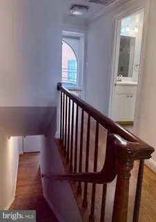 a view of entryway with wooden floor and stairs