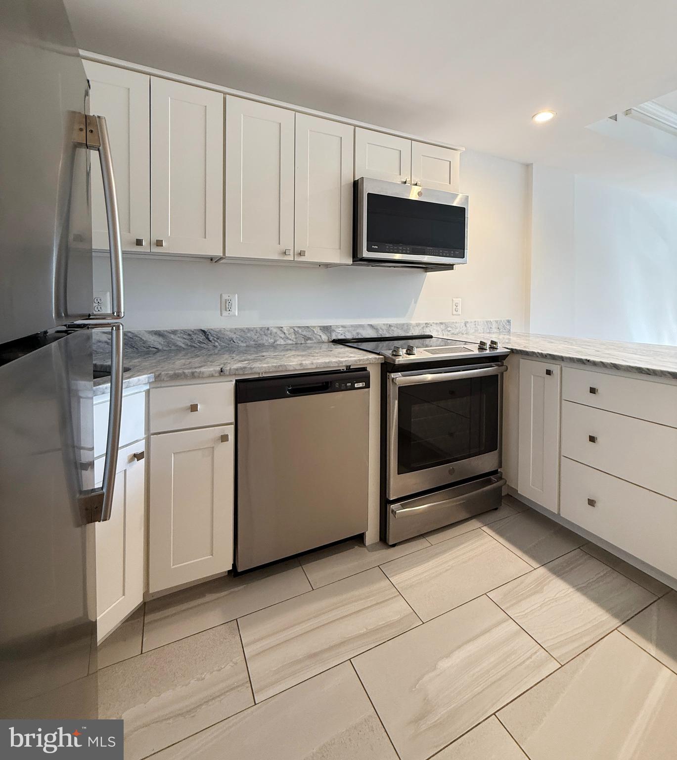 2719 M Street Northwest, Unit 2719 Washington, DC 20007 - Photo 6 of 21 a kitchen with stainless steel appliances granite countertop a stove a sink and a refrigerator
