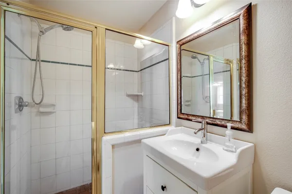 a bathroom with a sink toilet and shower