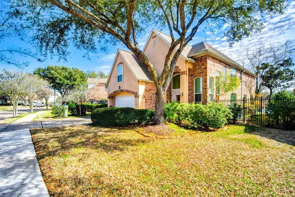 a yellow house with a outdoor space balcony and seating space