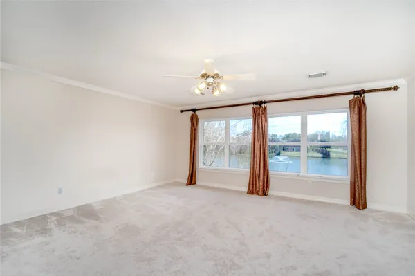 an empty room with chandelier fan