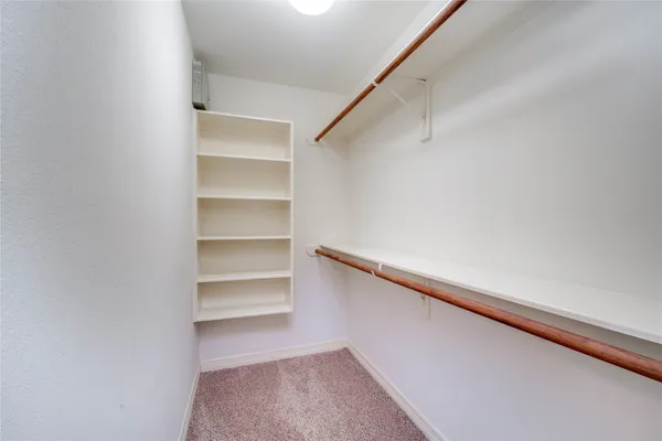 a view of a pathway with a wrought fence