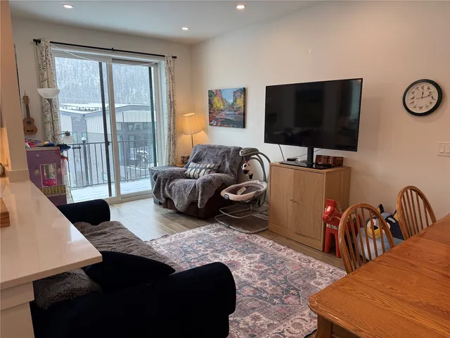 a bedroom with furniture and a flat screen tv