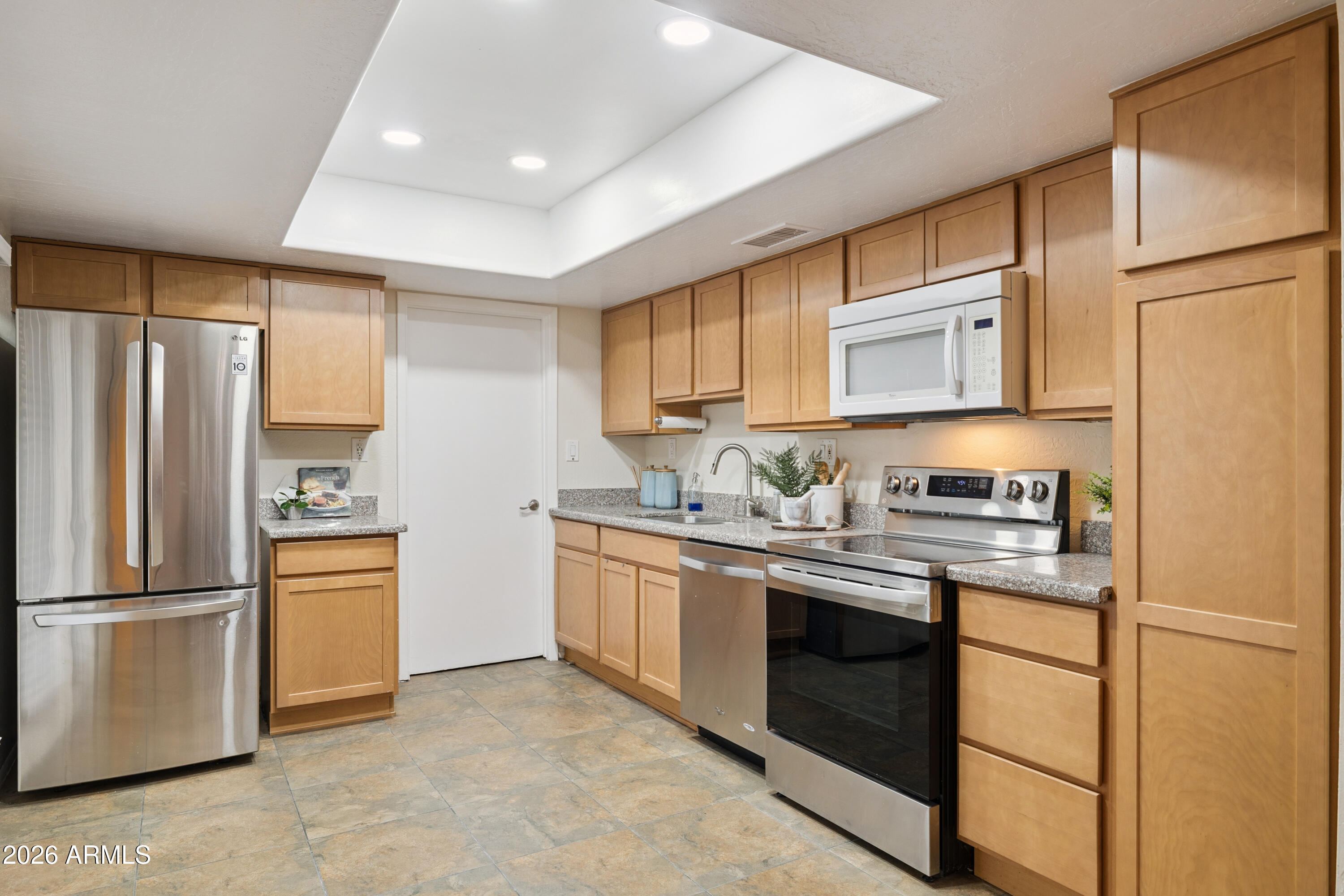 4343 East Osborn Road Phoenix, AZ 85018 - Photo 6 of 41 a kitchen with stainless steel appliances granite countertop a refrigerator sink stove and microwave