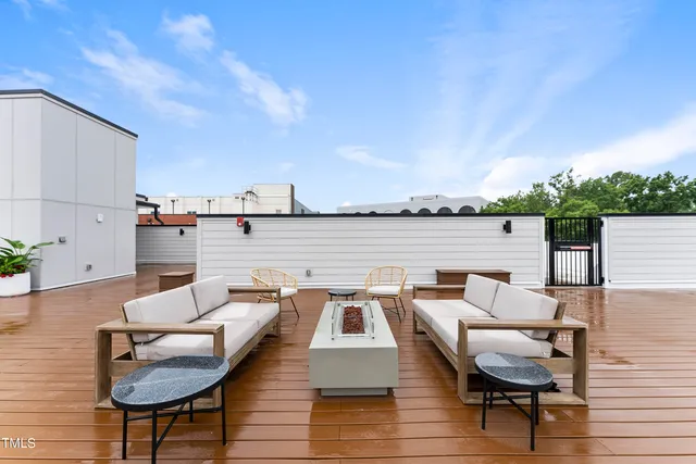 a terrace with outdoor seating and trees