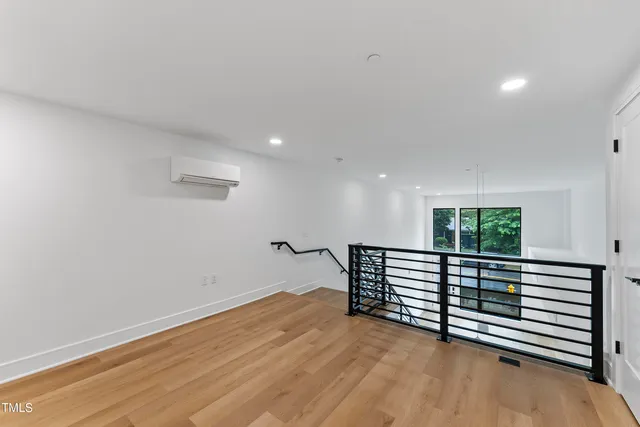 a view of a room with wooden floor and a window