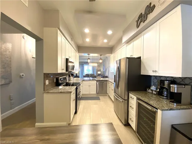 a kitchen with stainless steel appliances a stove cabinets and a refrigerator