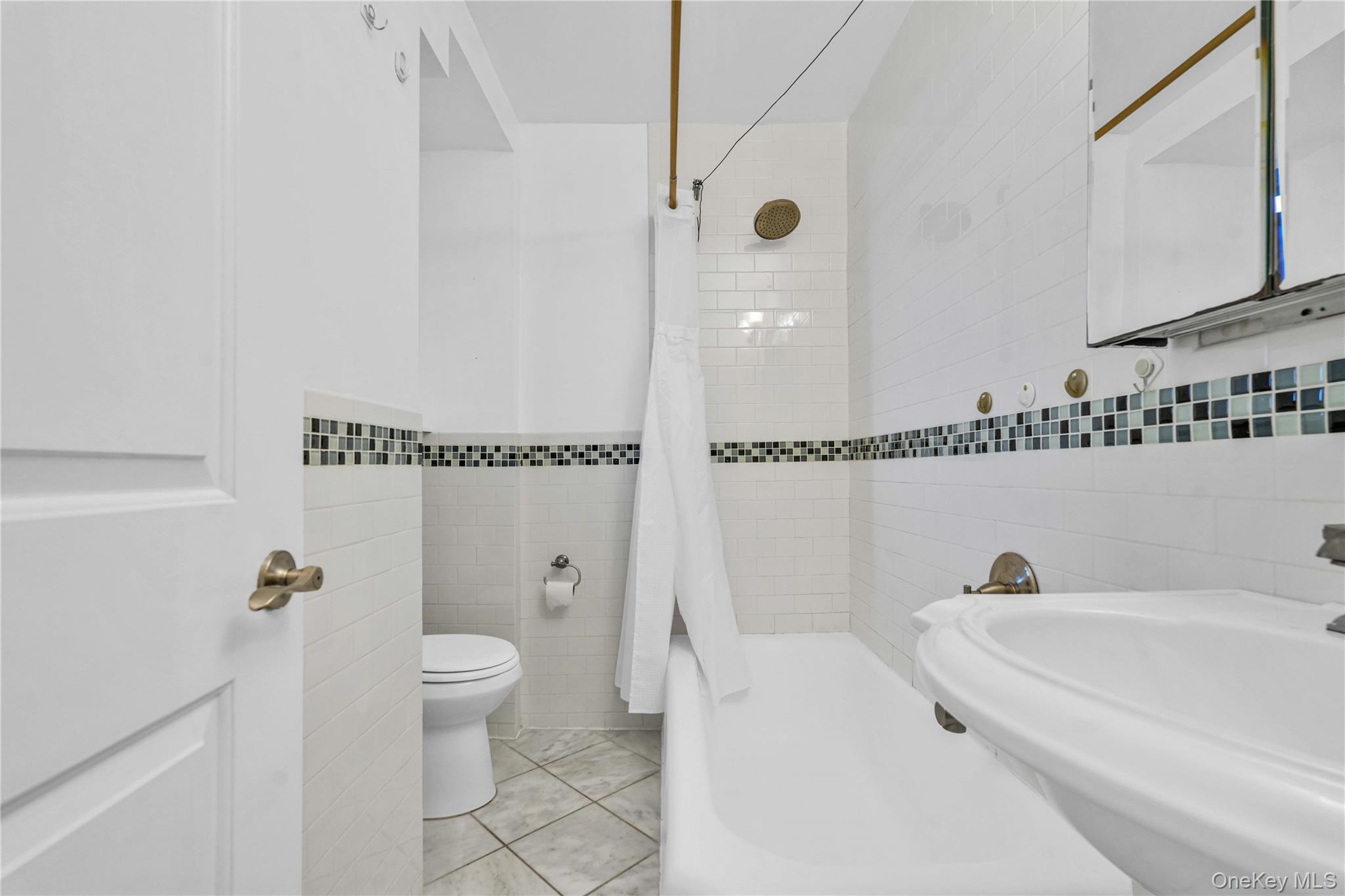 150-29 72nd Road, Unit 4H Queens, NY 11367 - Photo 12 of 16 a bathroom with a bathtub and a toilet