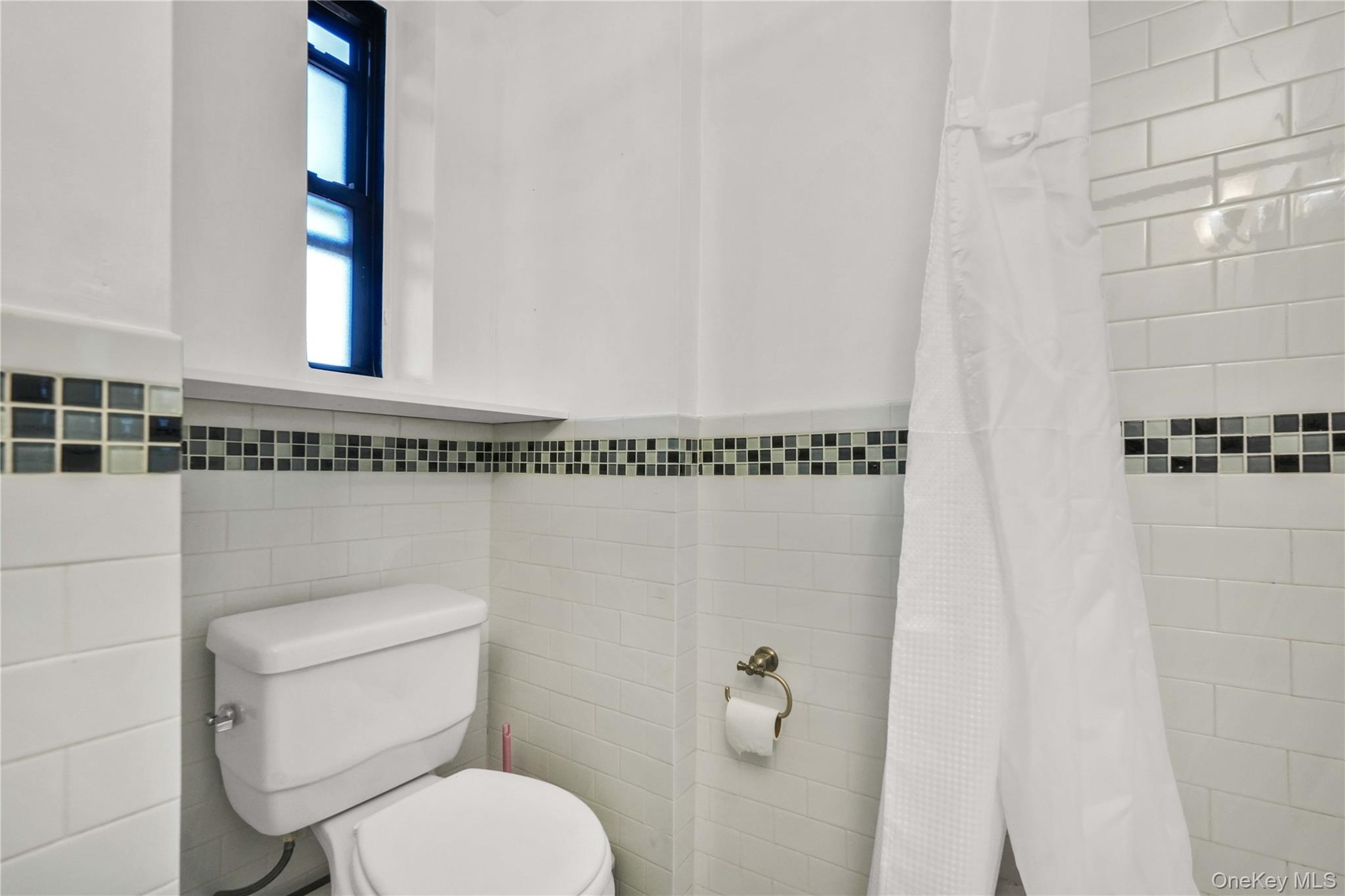 150-29 72nd Road, Unit 4H Queens, NY 11367 - Photo 13 of 16 a white toilet sitting next to a bathroom sink