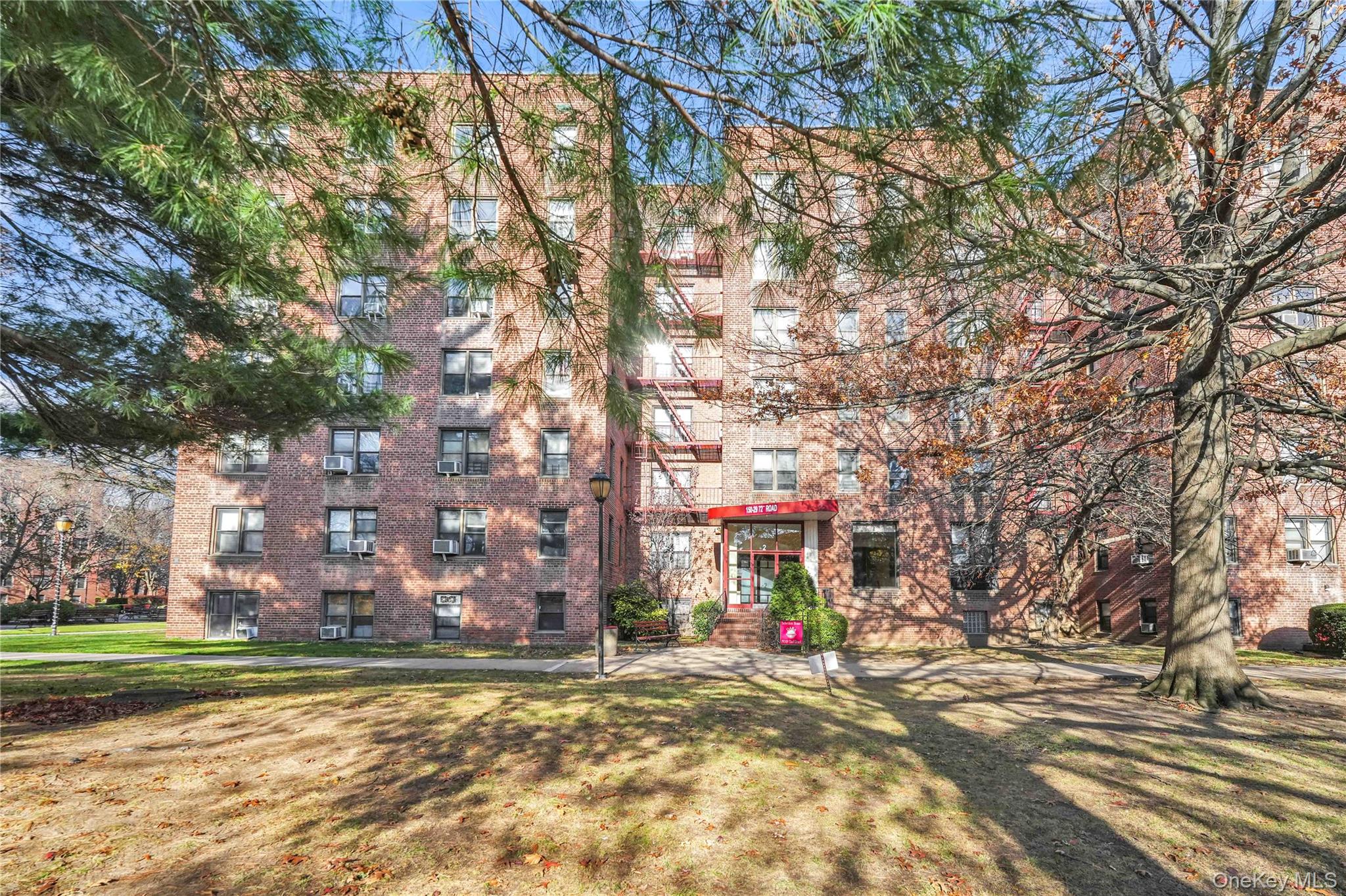 150-29 72nd Road, Unit 4H Queens, NY 11367 - Photo 14 of 16 a view of a city with tall trees