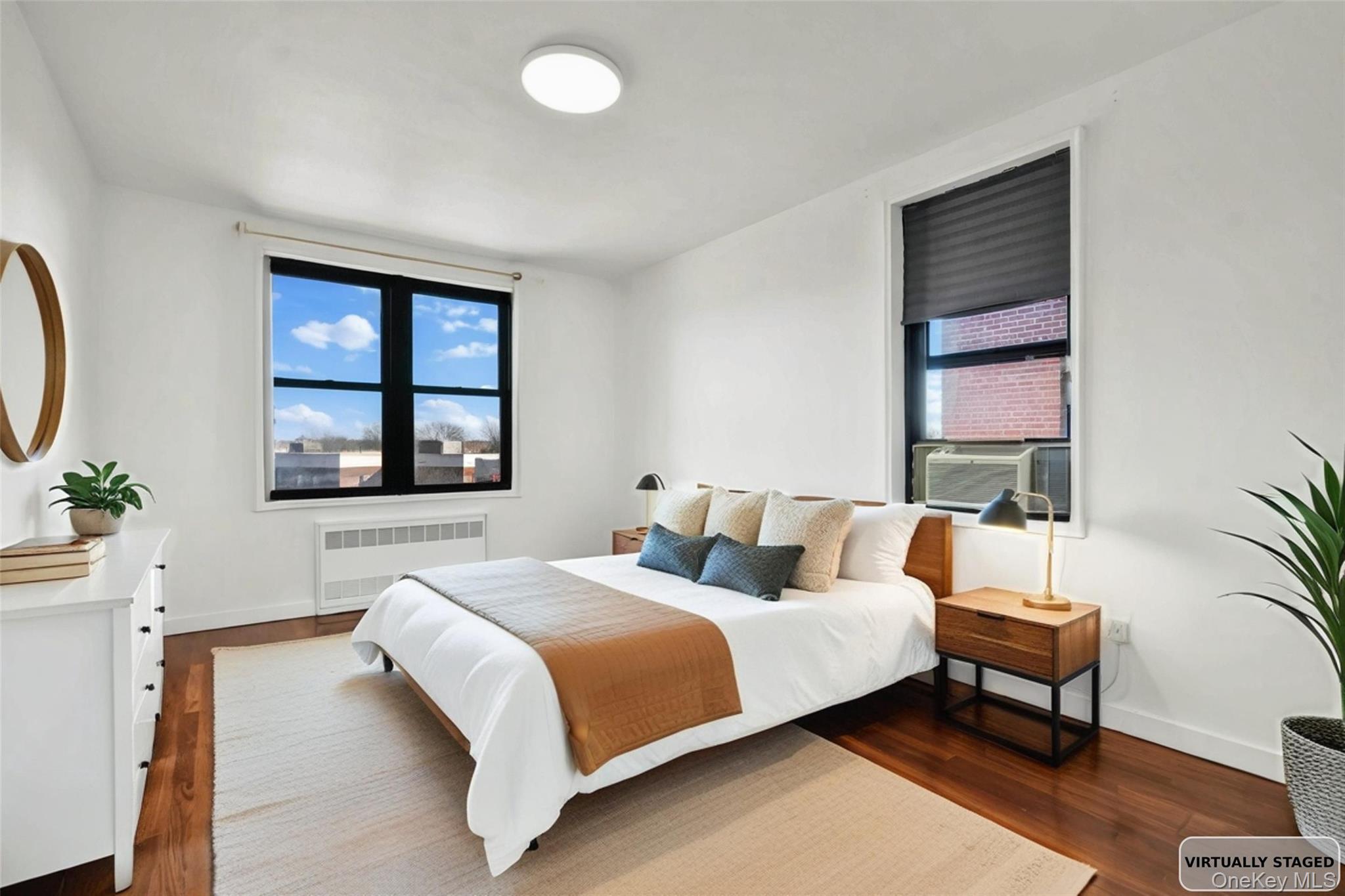 150-29 72nd Road, Unit 4H Queens, NY 11367 - Photo 3 of 16 a bedroom with a bed and a window