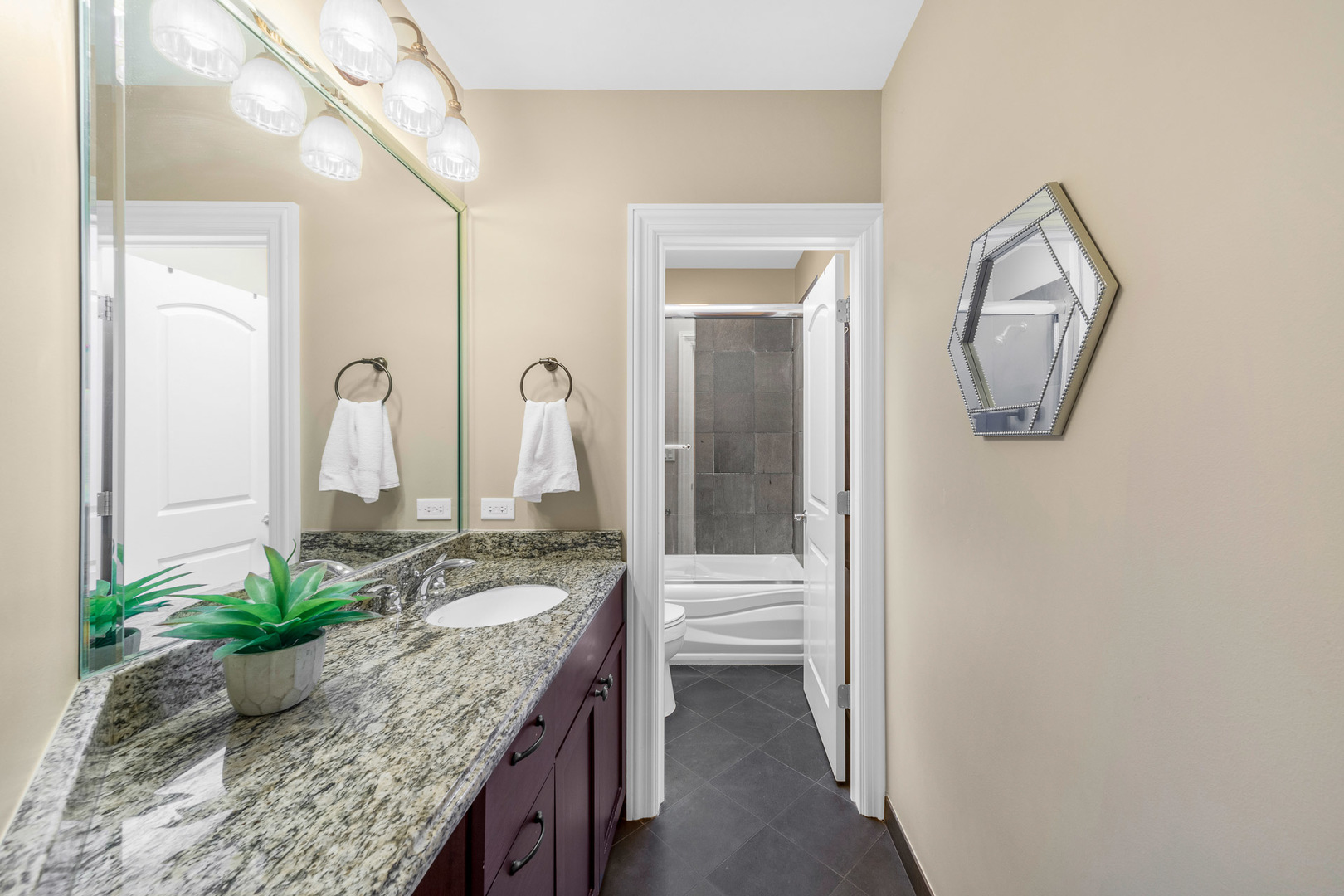 2235 Covert Road Glenview, IL 60025 - Photo 21 of 35 a en suite bathroom with a granite countertop sink and a mirror