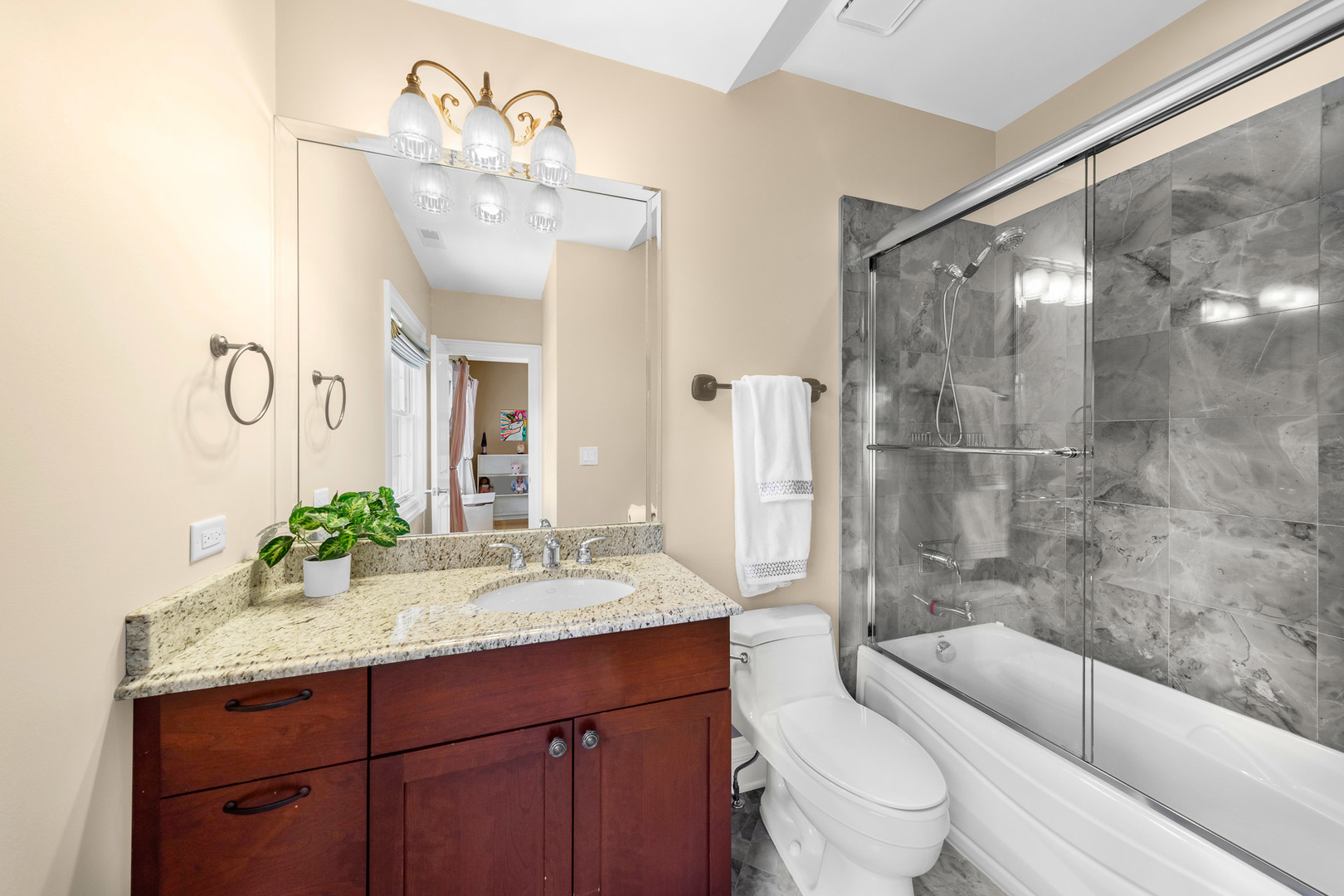 2235 Covert Road Glenview, IL 60025 - Photo 24 of 35 a bathroom with a bathtub shower sink mirror vanity and toilet