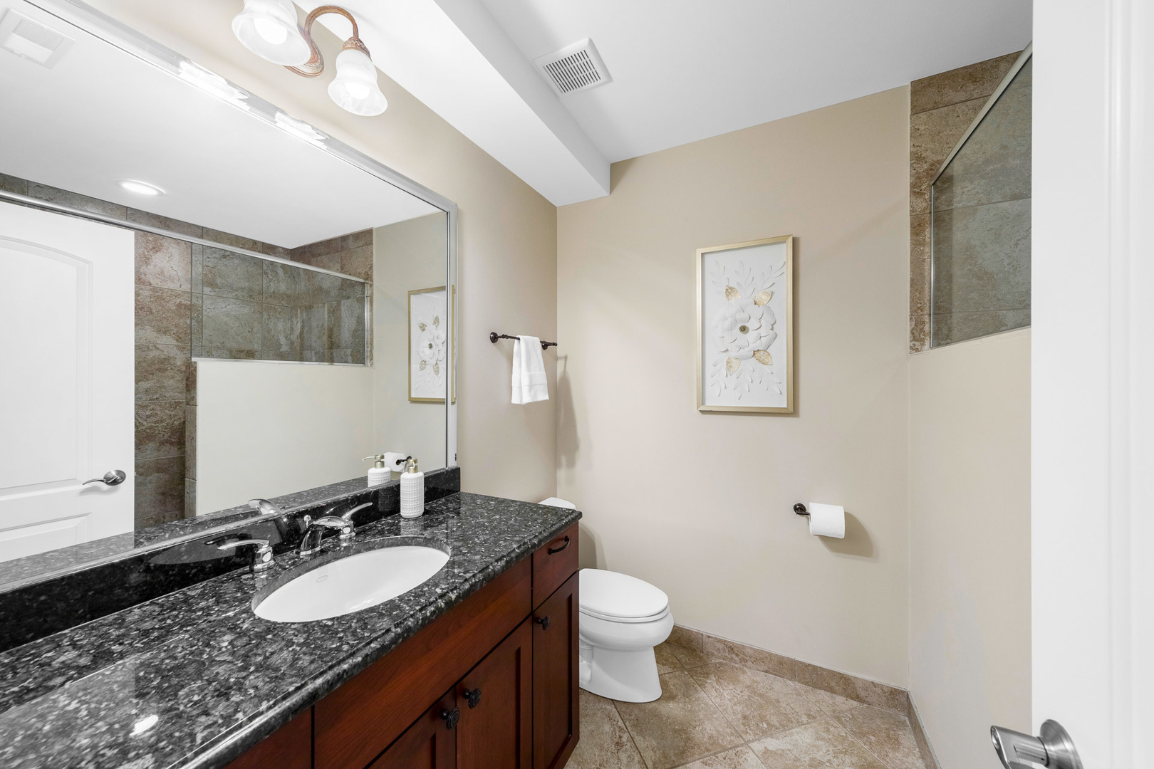 2235 Covert Road Glenview, IL 60025 - Photo 32 of 35 a bathroom with a granite countertop sink a mirror and a toilet