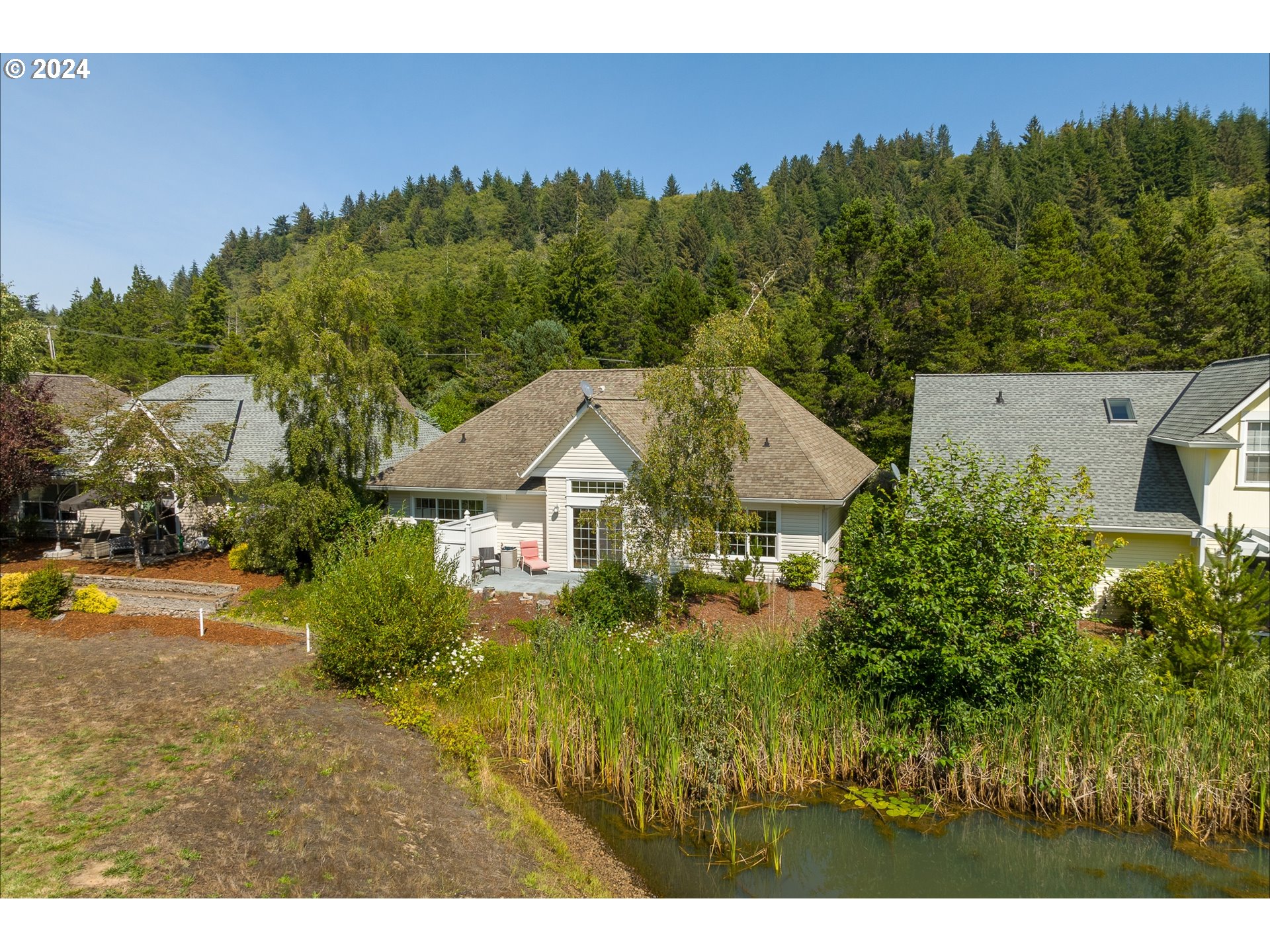 3 Waterford Downs Florence, OR 97439 - Photo 3 of 46 a view of a house with a big yard plants and large trees