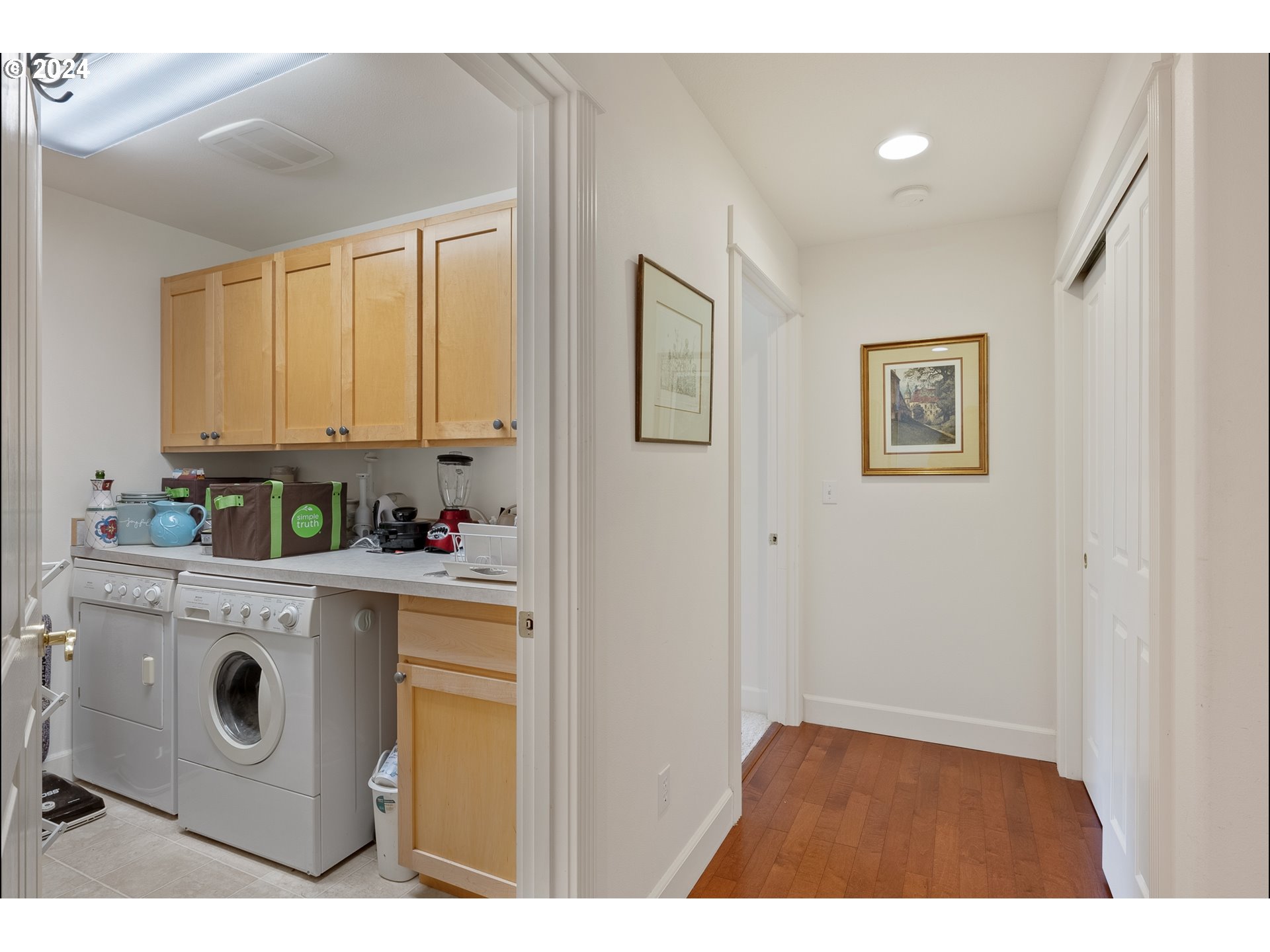 3 Waterford Downs Florence, OR 97439 - Photo 34 of 46 a kitchen with a stove a refrigerator a sink and white cabinets with wooden floor