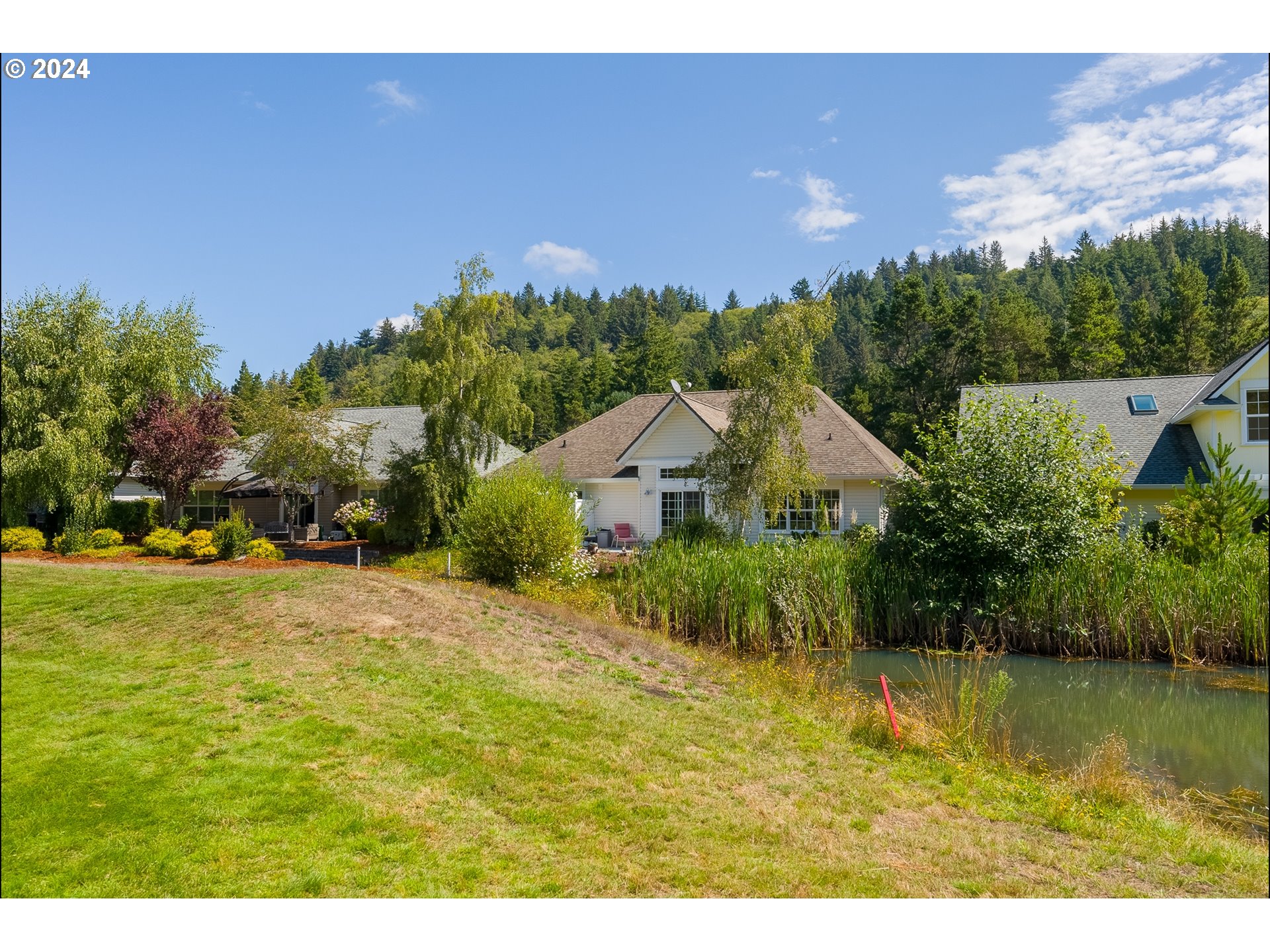 3 Waterford Downs Florence, OR 97439 - Photo 45 of 46 a aerial view of a house with a yard and lake view