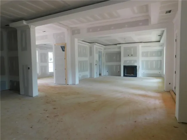 a view of empty room with a fireplace