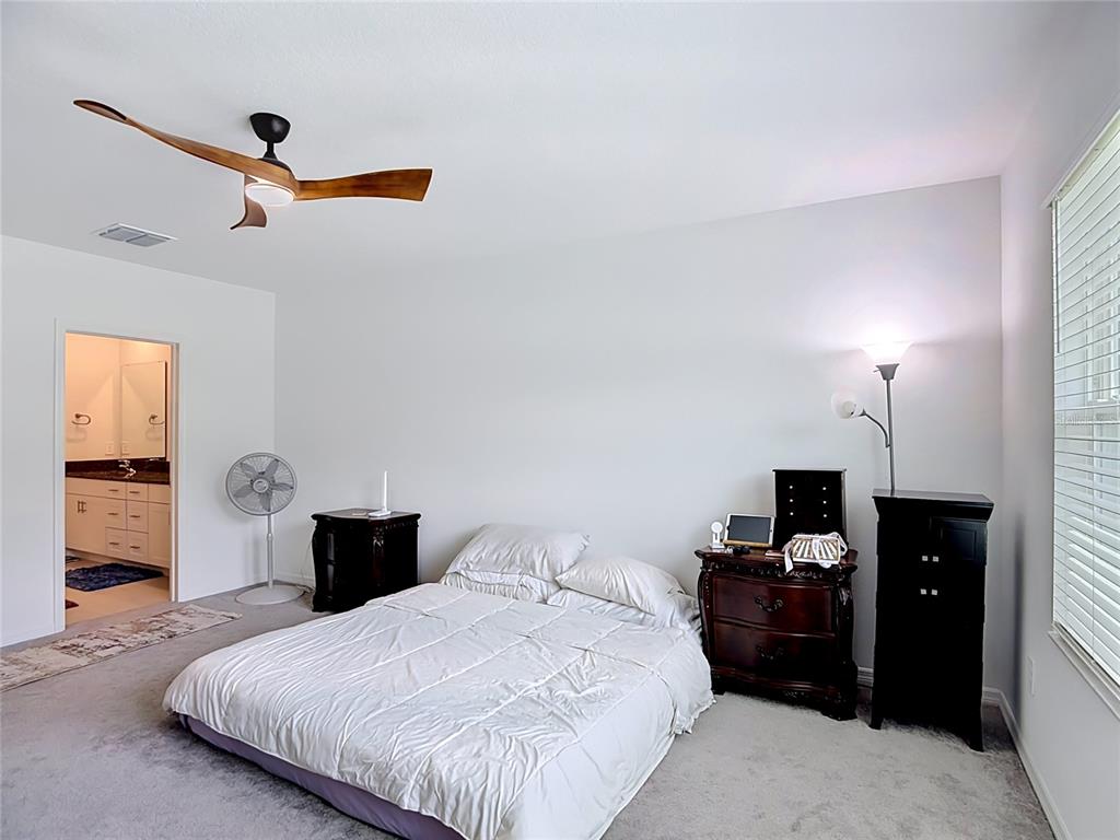 1633 Red Loop Lakeland, FL 33801 - Photo 23 of 60 a bedroom with a bed and dresser