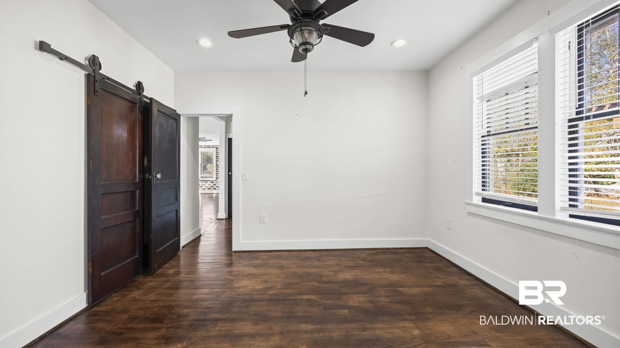 24701 Highway 98 Elberta, AL 36530 - Photo 16 of 32 Unfurnished bedroom featuring a barn door, dark wood-type flooring, recessed lighting, and a ceiling fan