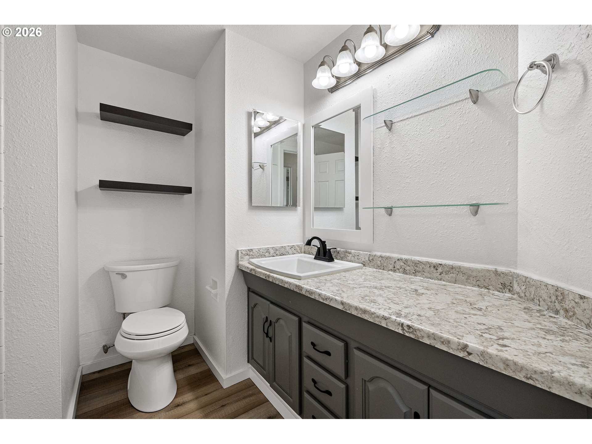 422 South 49th Place Springfield, OR 97478 - Photo 16 of 32 a bathroom with a granite countertop sink a toilet and a mirror