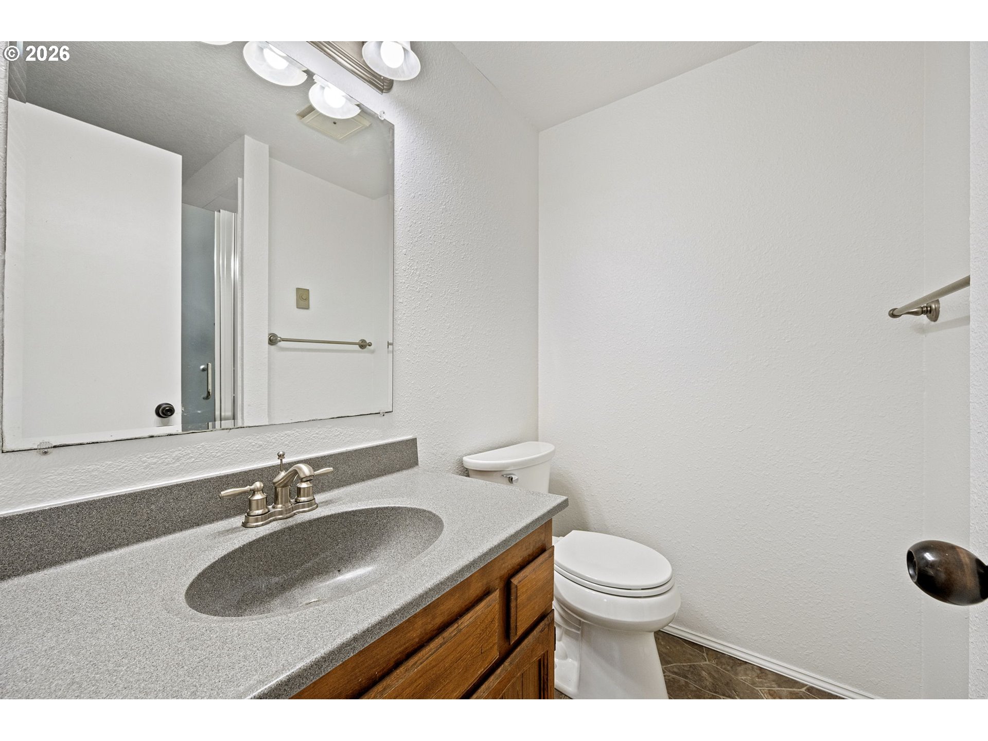 422 South 49th Place Springfield, OR 97478 - Photo 22 of 32 a bathroom with a sink a toilet and a mirror