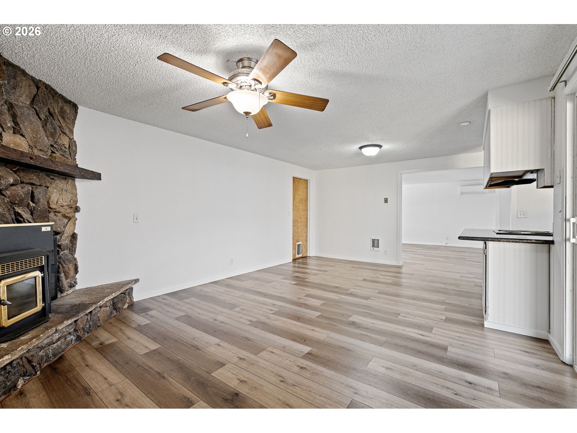 422 South 49th Place Springfield, OR 97478 - Photo 23 of 32 a view of empty room with wooden floor and fan