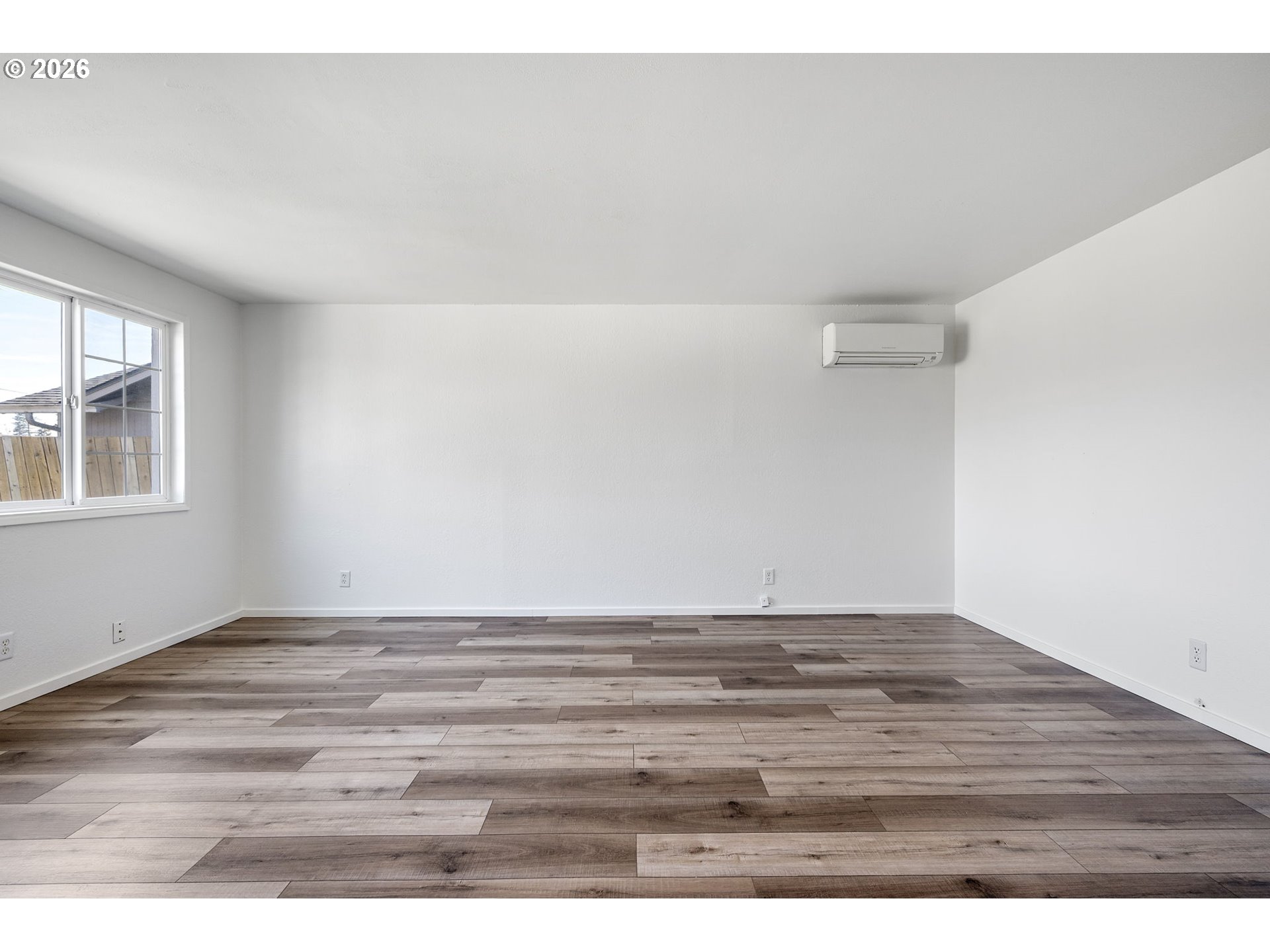 422 South 49th Place Springfield, OR 97478 - Photo 4 of 32 a view of an empty room with wooden floor and a window
