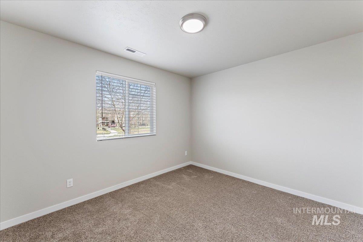 2517 East Goldstone Street Meridian, ID 83642 - Photo 13 of 22 Unfurnished room with baseboards and carpet flooring