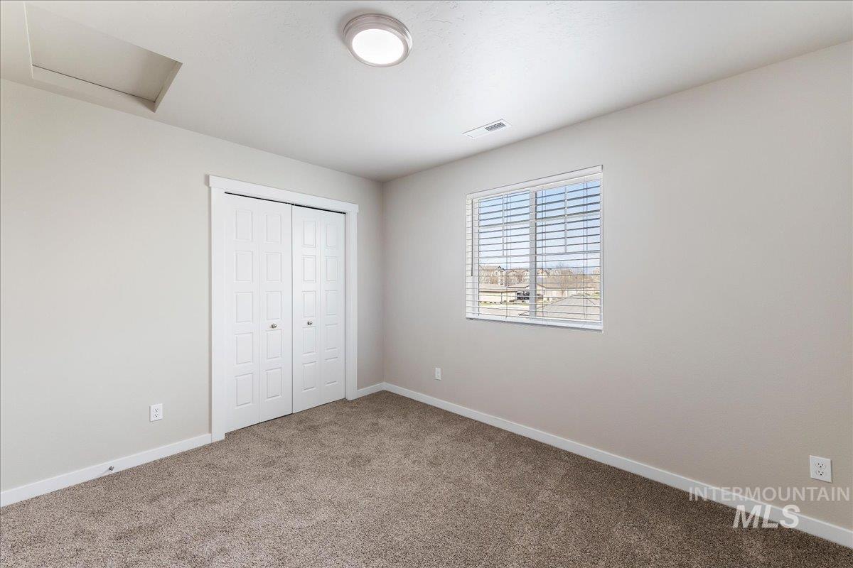 2517 East Goldstone Street Meridian, ID 83642 - Photo 14 of 22 Unfurnished bedroom featuring carpet and a closet