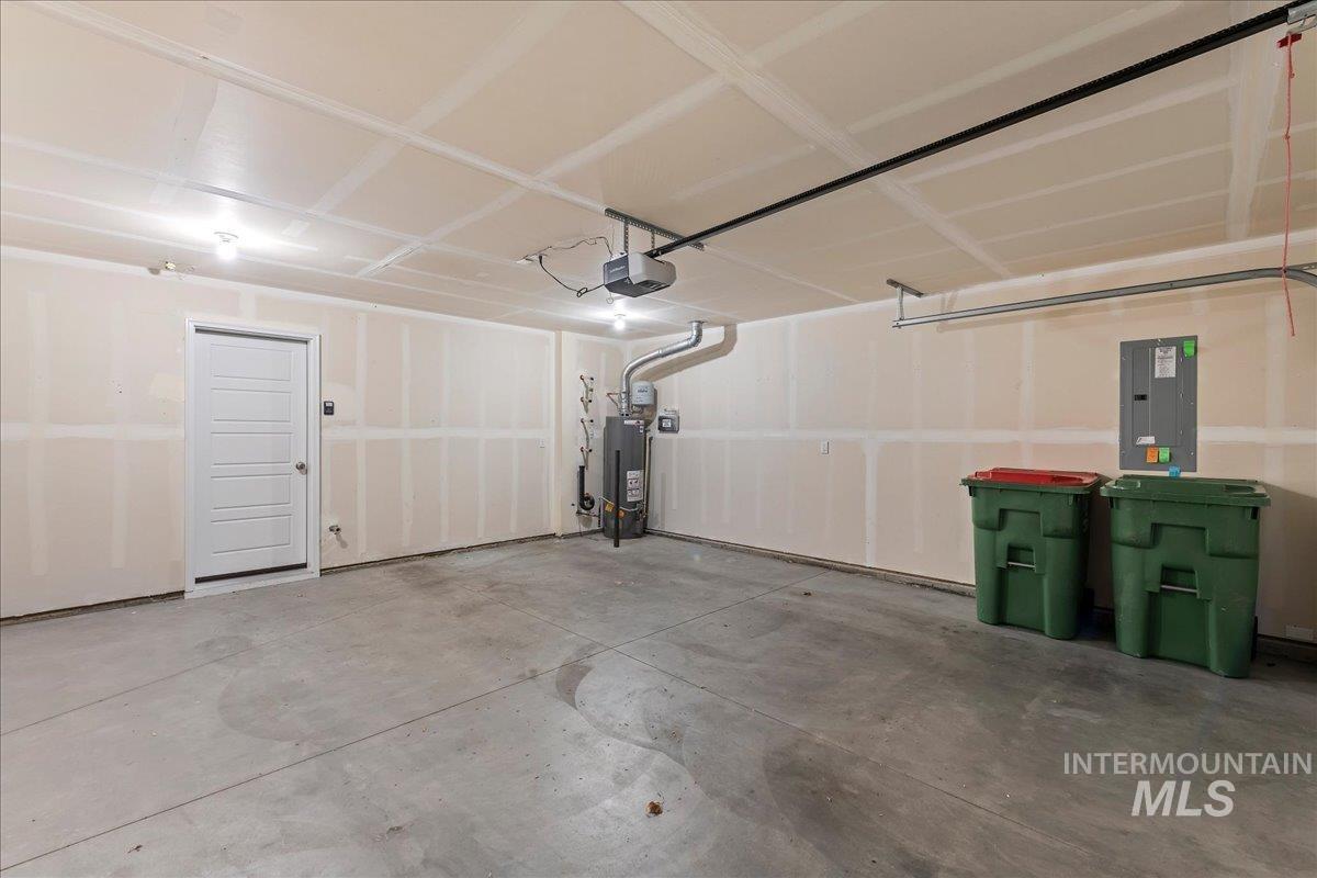2517 East Goldstone Street Meridian, ID 83642 - Photo 19 of 22 Garage with electric panel, water heater, and a garage door opener