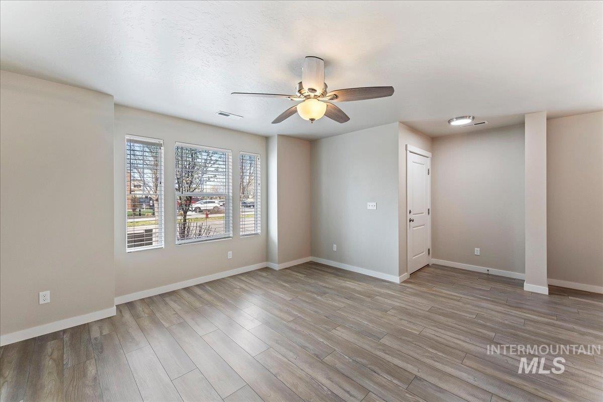 2517 East Goldstone Street Meridian, ID 83642 - Photo 5 of 22 Empty room featuring ceiling fan and light wood-style floors