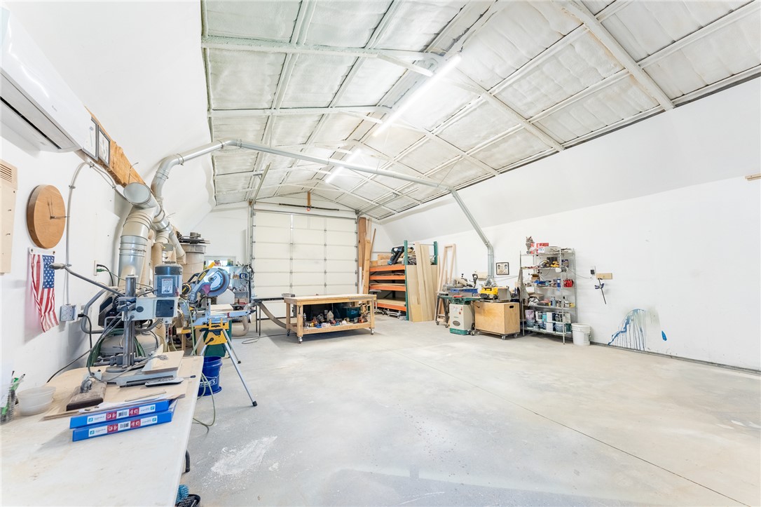 696 Mt Olivet Road Six Mile, SC 29682 - Photo 32 of 35 This spacious workshop offers ample room for projects and storage, featuring durable concrete flooring.