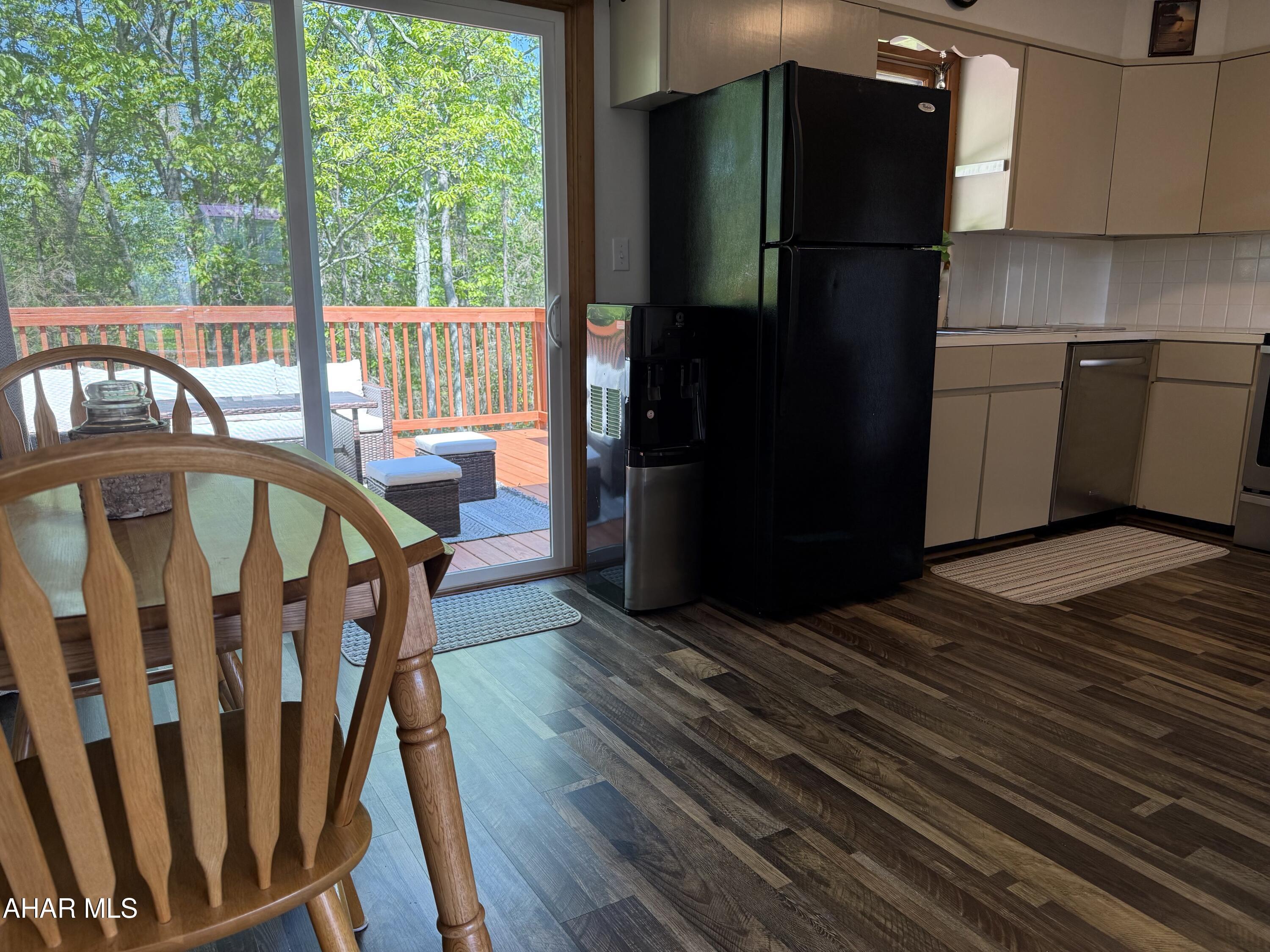 473 Calhoun Road Everett, PA 15537 - Photo 10 of 45 a kitchen with wooden floors a refrigerator and a view of living room