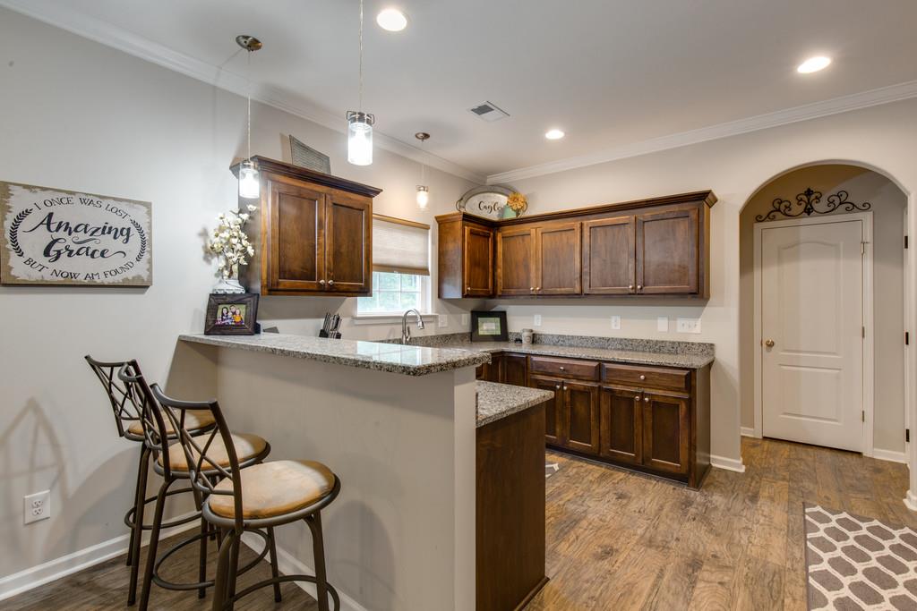 257 Abbey Road Lebanon, TN 37090 - Photo 7 of 18 a kitchen with stainless steel appliances granite countertop a stove top oven a sink and a refrigerator