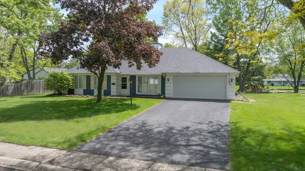a view of a house with a yard and tree s